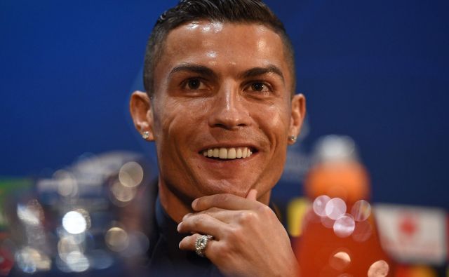 Cristiano Ronaldo je na novinarski konferenci večkrat poudaril, da je srečen človek. FOTO: AFP