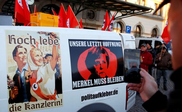 Med obiskom Angele Merkel v Chemnitzu so se oglasili tudi protestniki, ki pravijo »Naj živi kanclerka!« in »Kanclerka mora ostati«. FOTO: Reuters