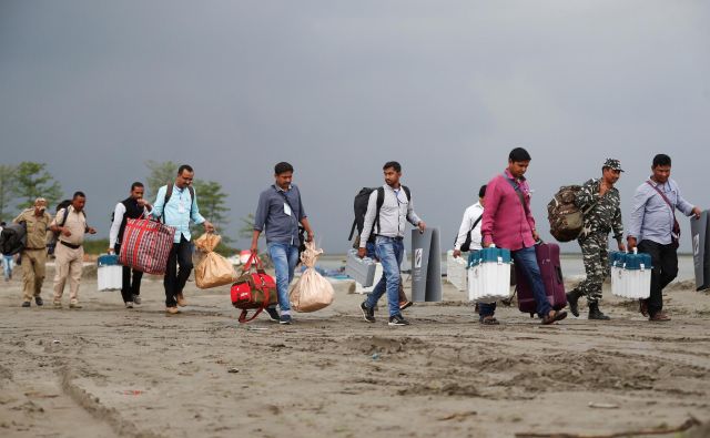 Elektronske volilne naprave utirajo pot na volišča v okrožju Jorhat v indijski zvezni državi Asam. Parlamentarne volitve bodo trajale do 19. maja. FOTO: Reuters