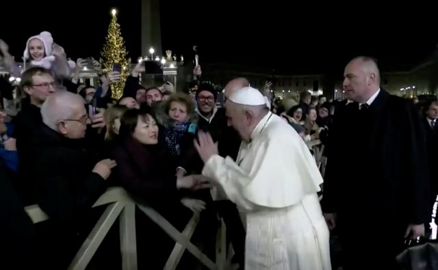 Jože Debevc: »Ko se je papež Frančišek podal med množico, ga je ena od teh prijela za roko in ga nekoliko povlekla k sebi. Njegova reakcija je bila hitra in sunkovita: prav nič nežno jo je udaril po njeni iztegnjeni roki.« Foto Reuters