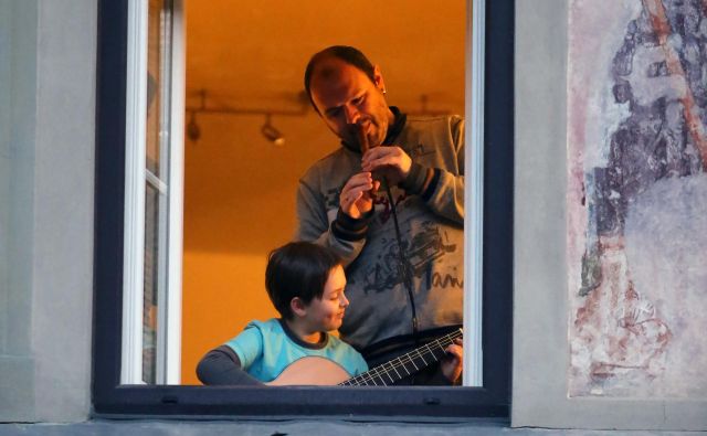 Klarinetist Goran Bojčevski in njegov sin Taras sta sinoči muzicirala ob odprtem oknu v Celju. FOTO: Andraž Purg - GrupA