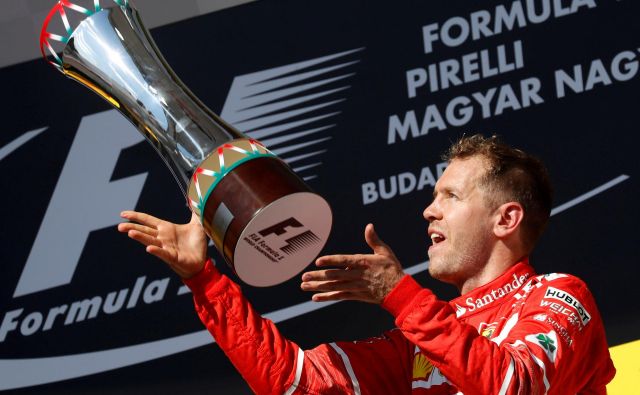 Sebastian Vettel si želi, da bi se v prihodnje pri Ferrariju še tako veselil, kot se je pred tremi leti po zmagi v Budimpešti. FOTO: Reuters