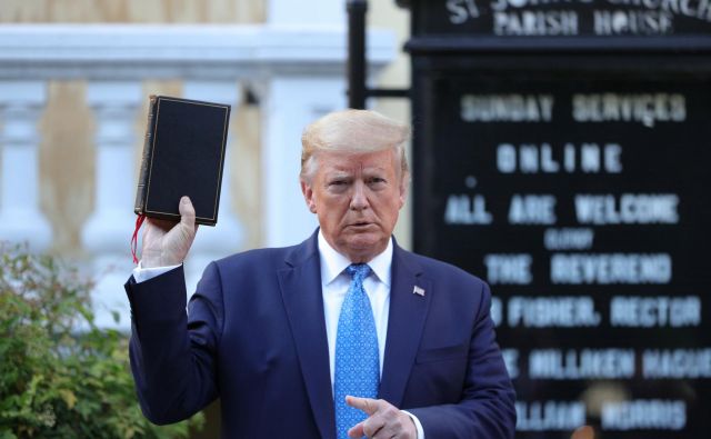 Ameriški predsednik Donald Trump z Biblijo v roki po razganjanju protestnikov pred Belo hišo. FOTO: Tom Brenner/Reuters