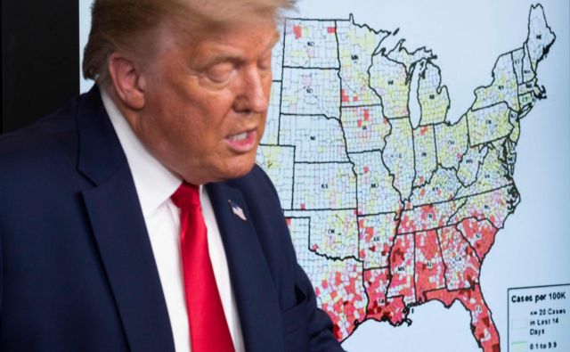 Ameriški predsednik Donald Trump pred zdravstvenim zemljevidom svoje države. FOTO: Jim Watson/AFP