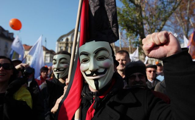 Maske, ki so simbol gibanja Anonymous, so pogoste tudi na protivladnih protestih v Sloveniji. FOTO: Jože Suhadolnik/Delo